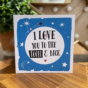 A geordie card with I love you to the toon and back printed in a big white moon on a blue starry background