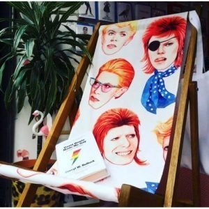 A fabulous Bowie deck chair with a timber frame and with a faces of bowie canvas seat.