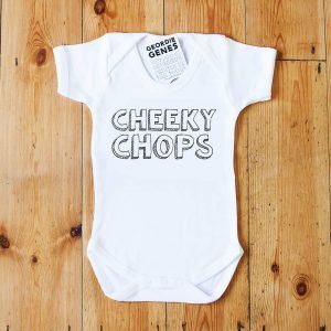 A white geordie baby vest that says cheeky chops in bold lettering in black and white