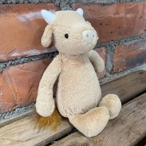 A gorgeous, cute little cow, creamy brown in colour, with short white horns and a creamy snout. Floppy ears and a tubby belly makes this cow so sweet and huggable!