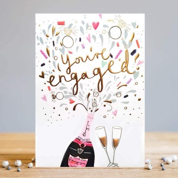 An engagement card with a bottle of bubbly and two glasses