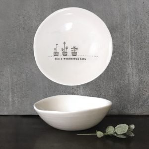 A white porcelain bowl from East of India. Printed inside with its a wonderful life and illustrated with 3 little plants