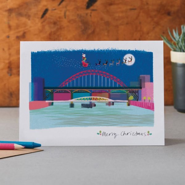 A christmas card featuring the Tyne bridge and Santa with his sleigh and reindeers flying over.