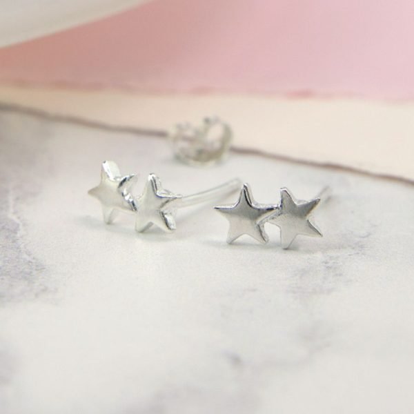 A pair of silver double star earrings. The 2 little stars are welded together on one stem.