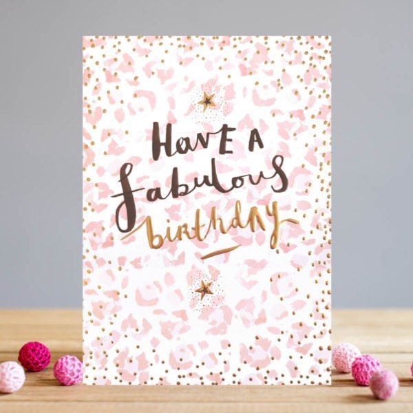 A rectangular card with a pink printed pattern in the background with the words Have a Fabulous Birthday printed in black and gold foil. The card has embossed spots which have been printed with gold foil on too.