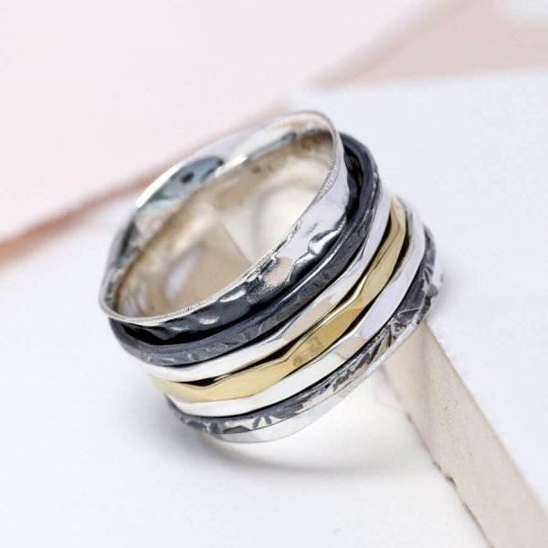 A silver ring with 5 spinning bands in various textures to give definition