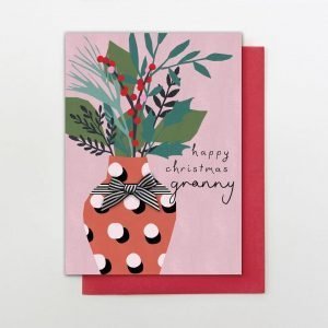 A luxury Christmas card with the words "Happy Christmas Granny". With a Christmas bouquet of flowers in a vase finished with a hand tied black and white stripy bow