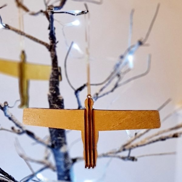 A wooden Angel of the North hanging tree decoration in burnt gold