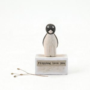 A cute little wooden penguin keepsake from East of India, on a small wooden block with the words 'Flippin Love You' printed on it.