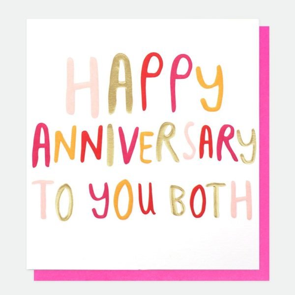 A white card with colourful lettering with the words 'Happy Anniversary to you Both' printed on it