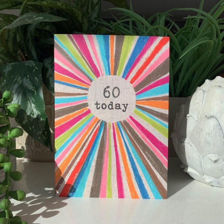 A multi coloured rainbow card with the words 60 today printed in the centre of it.