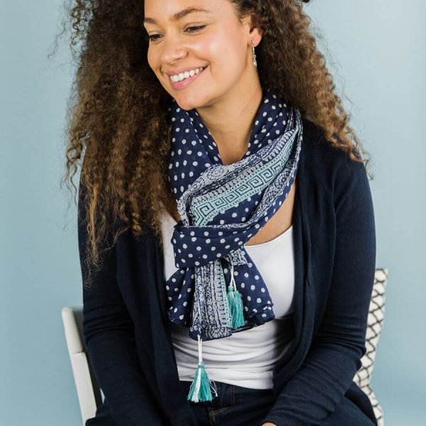 Navy Blue Polka Dot Scarf. A navy blue scarf with white polka dots and an aqua blue aztec patterned border and aqua blue tassels