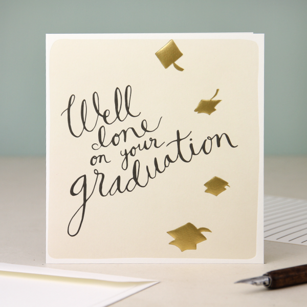 A cream card with gold mortar board hats and the words well don on your graduation in black hand writing