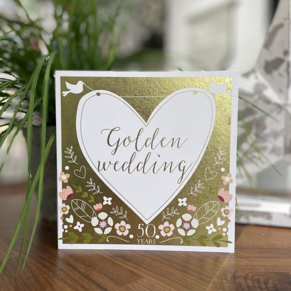 A lovely gold card with floral design and a large white heart with little white doves on it. The words Golden Wedding are printed in the centre of the heart