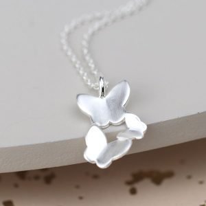 A silver necklace with 3 flying butterfly charm and fine silver chain