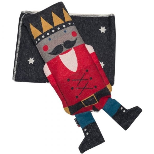 A grey and white reversible blanket with stars contained in a nutcracker puppet