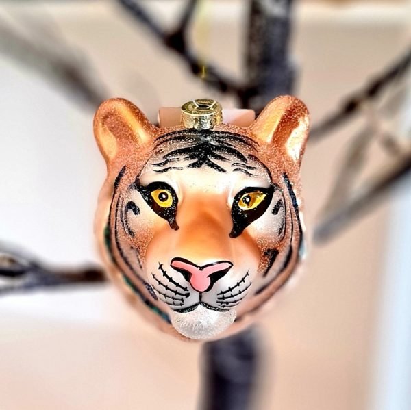 A glass tigers head decoration in gold glass with black glitter stripes and a lovely pink nose.