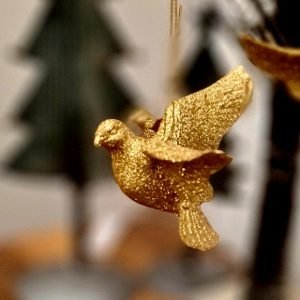 A gold glitter bird hanging decoration