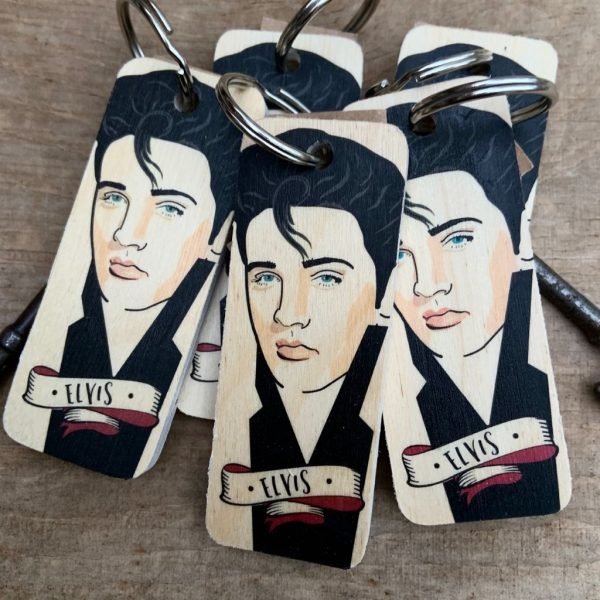 A wooden key ring with an illustration of Elvis Presley in a caricature style