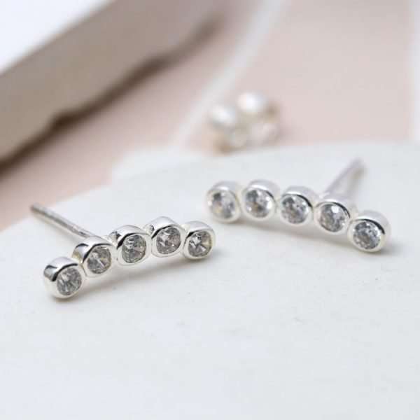 A pair of silver cubic zirconia stud earrings with five little jewels.