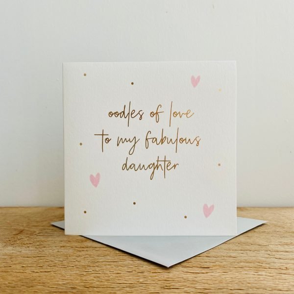 A square white card with gold spots and pink hearts on it and the words Oodles of Love to my Fabulous Daughter in gold print