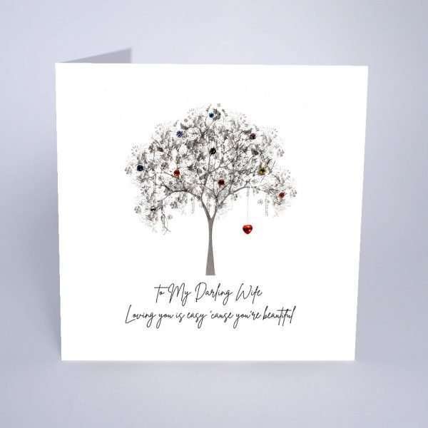 To My Darling Wife Valentine's Day Card by Five Dollar Shake.. A luxury white shimmering board printed with a tree with a red crystal heart hanging from the tree. Embellished with colourful crystals. The caption reads ""To My Darling Wife Loving you is easy 'cause you're beautiful""