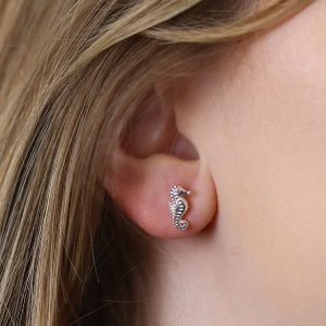 A lovely pair of sterling silver stud earrings that are shaped like seahorses.