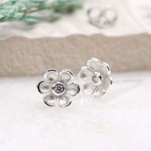 A pair of sterling silver daisy studs with cubic zirconia centre