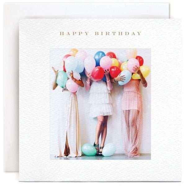 Girls With Balloons Birthday Card. A white square card with a photograph of three young ladies in party dresses holding balloons that obscure their faces. The caption reads "