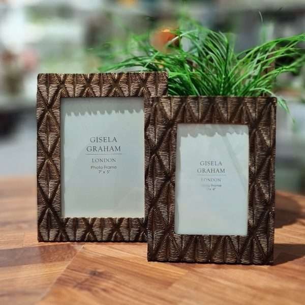 Picture frames in two sizes made of resin with a bronze finish and an engraved diamond pattern