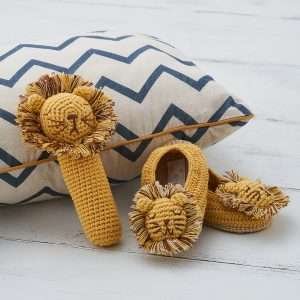 A cotton crochet lion stick rattle in yellow