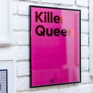 A pink print with the words Killer Queen printed in a red shimmer effect and with a QR code on the bottom of it that allows you to play the song on a Smart phone.