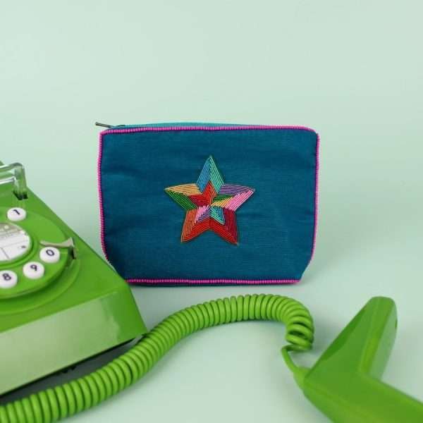 A blue velvet coin purse with a beaded rainbow star motif