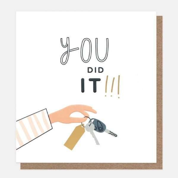 A congratulations for passing your driving test card with a hand holding a set of car keys and you did it ! caption