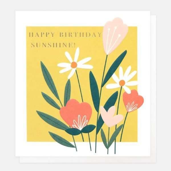 A birthday card with a yellow background and a contemporary floral design and happy birthday sunshine in gold foil lettering