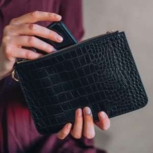 A vegan leather black mock croc pouch for makeup or a clutch bag