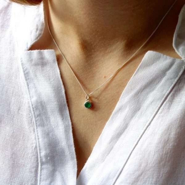 A sterling silver necklace with a birthstone pendant