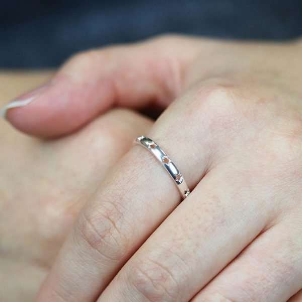 Sterling silver ring with smooth rounded surface and star cut-out pattern around the band
