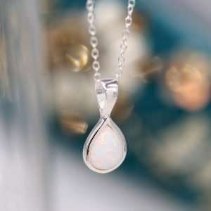 Sterling silver teardrop shape pendant with a synthetic white opal inset and fine silver chain