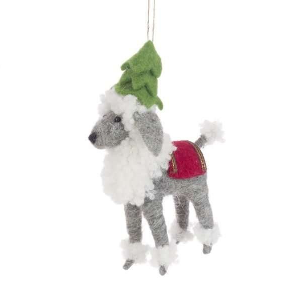 A felt poodle with a red coat and a green felt Christmas tree on his head