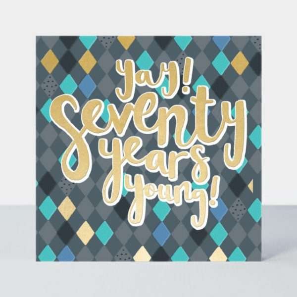 A 70th birthday card with a dark geometric pattern and yay seventy years young in gold foil lettering