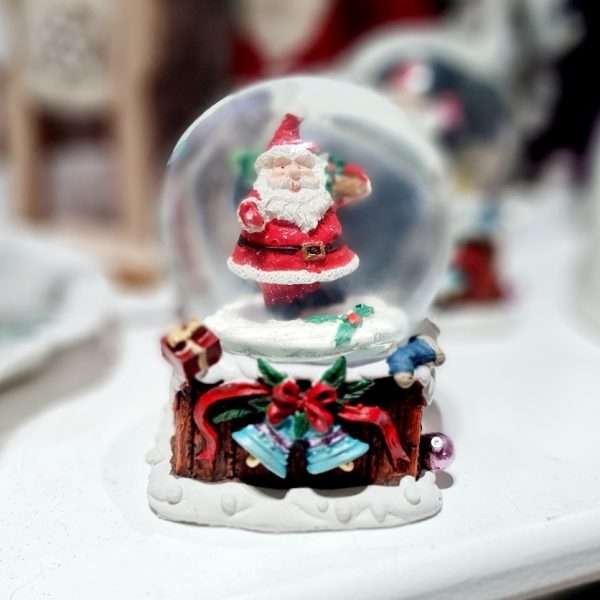 A snow globe with a cute santa