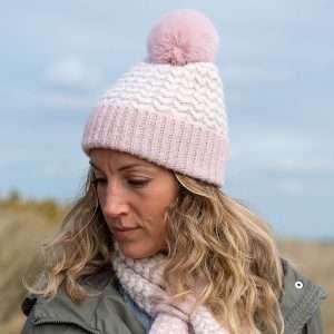 A lovely pink heart knit bobble hat with a fluffy faux fur pompom