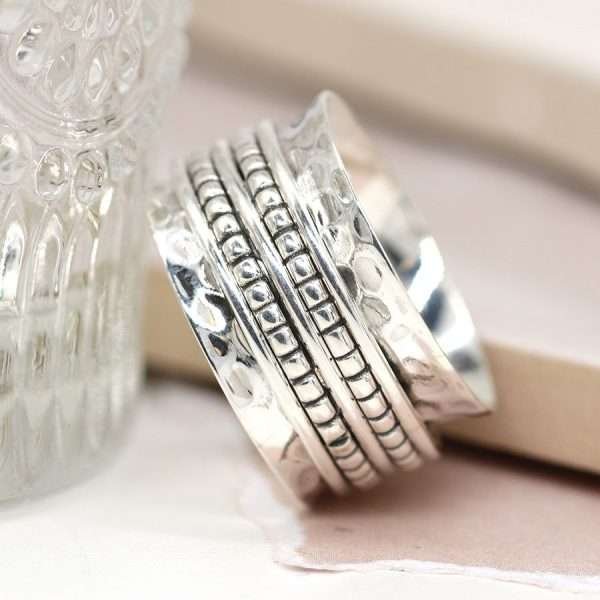 Sterling silver hammered wide band spinning ring with decorative silver dotted moving bands