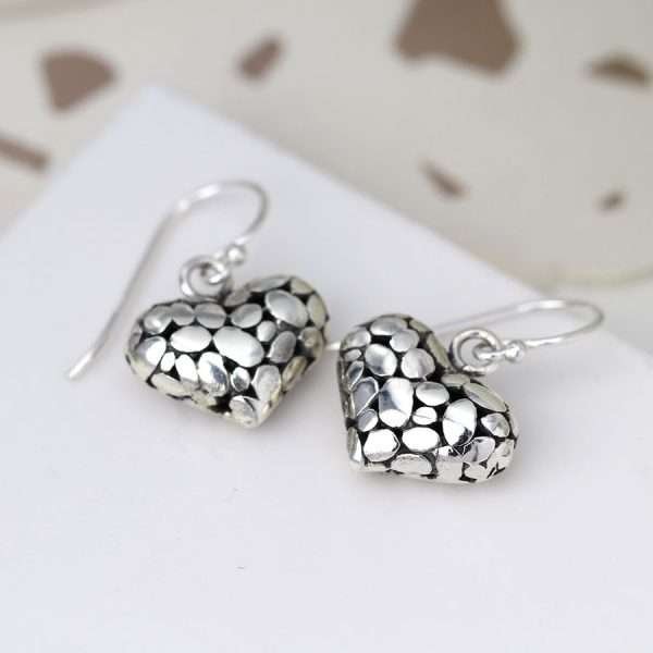 Sterling silver rounded pebble heart drop earrings with a smooth polished surface on fine silver earring hooks.