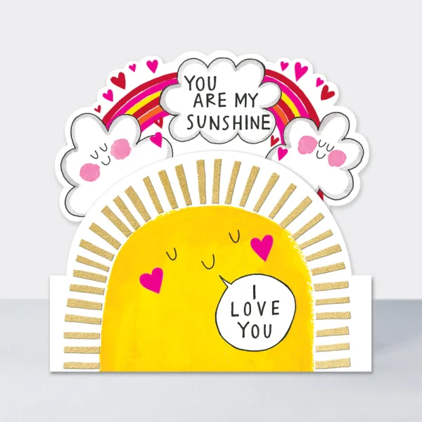 A die cut card with a big sunshine and a rainbow with you are my sunshine written on it