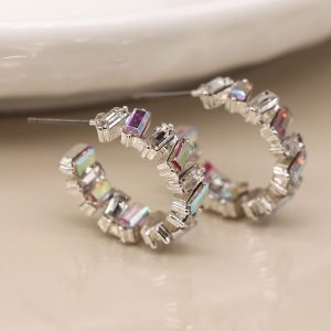 Silver plated open hoop stud earrings created by staggered claw settings, each containing a faceted oblong clear crystal with a pearlescent style