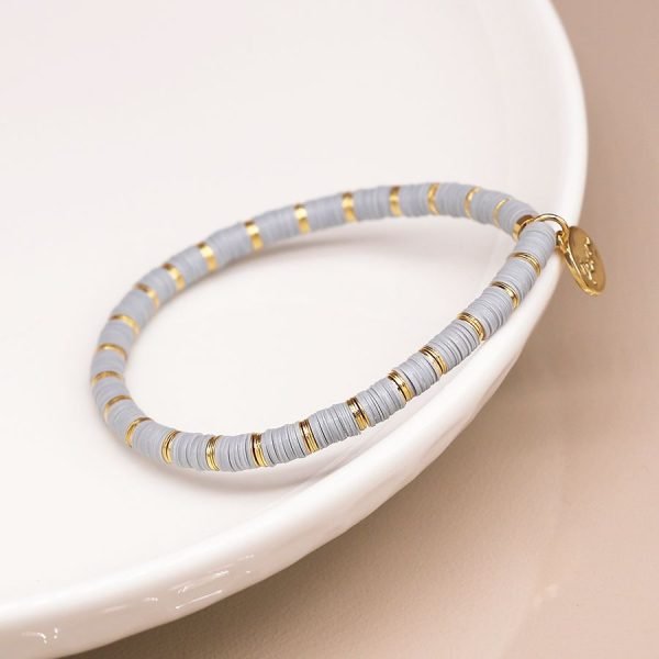 Dove grey fimo bead bracelet with golden spacers, finished with a golden POM tag