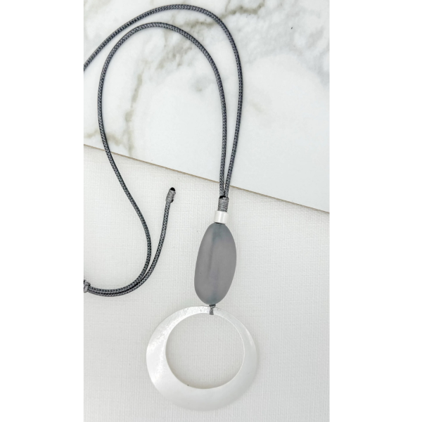 Adjustable long black cord necklace with silver open circle pend